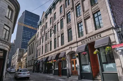 a street in a city with tall buildings at Hotel Bonaparte in Montréal