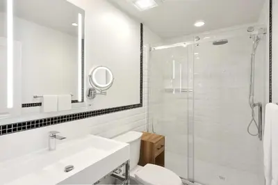 a bathroom with a toilet and a sink and a shower at Hotel Bonaparte in Montréal