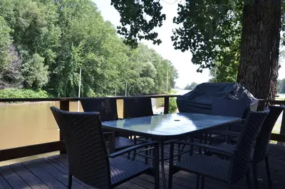 a table and chairs sitting on a deck at Pourvoirie Stéphane Marin in Maskinongé