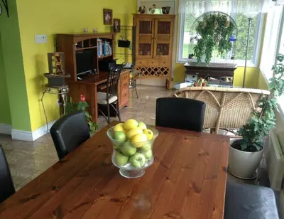 a dining room table with a bowl of fruit on it at Maison Parc Delormier in Trois-Rivières