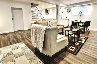 a living room with a couch and a table at Cosy apartment at Bossuet road in Montréal