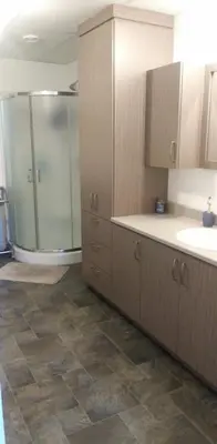 a kitchen with a sink and a shower in it at Casa Linda Victoriaville in Princeville