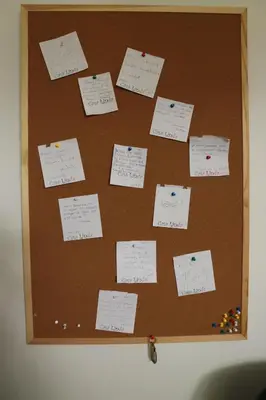 a bulletin board with sticky notes on it at Casa Linda Victoriaville in Princeville