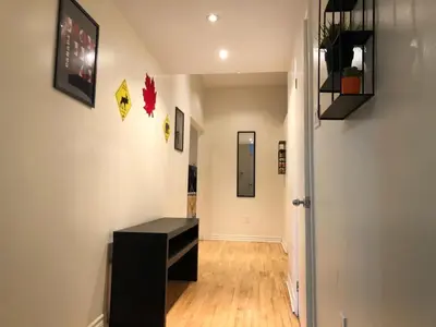 a hallway with a black dresser in a room at Le Duplex VIP in Montréal