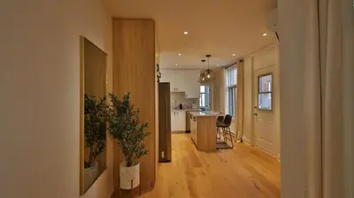 a hallway with a kitchen and a living room at Le Duplex VIP in Montréal
