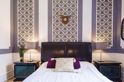 a bedroom with a large bed with two night stands at MtlVacationRentals - Appartements Plateau-Mont-Royal in Montréal