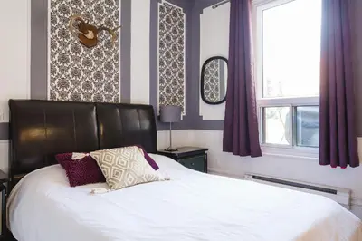 a bedroom with a bed and a window at MtlVacationRentals - Appartements Plateau-Mont-Royal in Montréal
