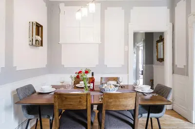 a dining room with a wooden table and chairs at MtlVacationRentals - Appartements Plateau-Mont-Royal in Montréal