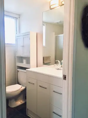 a bathroom with a toilet and a sink and a mirror at Le Jackrabbit Orford Domaine Cheribourg in Orford