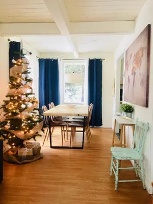 a dining room with a christmas tree and a table at Le Jackrabbit Orford Domaine Cheribourg in Orford