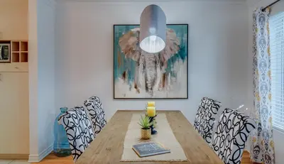 a dining room with a wooden table and chairs at Condo Entre Ville et Nature 2 in Magog-Orford