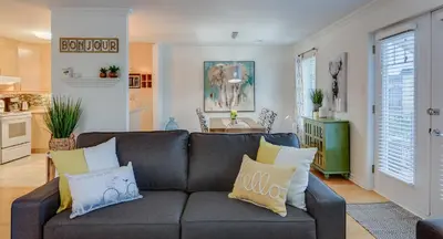 a living room with a couch and a kitchen at Condo Entre Ville et Nature 2 in Magog-Orford