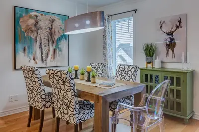 a dining room with a wooden table and chairs at Condo Entre Ville et Nature 2 in Magog-Orford