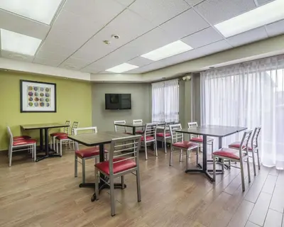a conference room with tables and chairs and a tv at Comfort Inn Thetford Mines in Thetford Mines