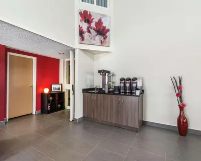 a room with a cash register and a red wall at Comfort Inn Thetford Mines in Thetford Mines