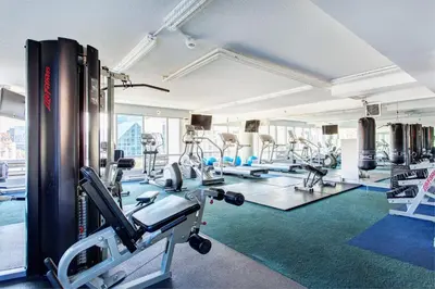 a gym with cardio equipment in a hotel room at Le Mille Neuf Apartments Modern Comfort in Downtown Montreal in Montréal
