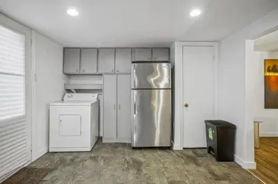 a kitchen with a stainless steel refrigerator and a dishwasher at Appart SS avec bain tourbillon CITQ 3I8I25 in Mascouche