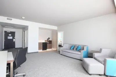 a living room with a couch and a table at Courtyard by Marriott Montreal Brossard in Brossard