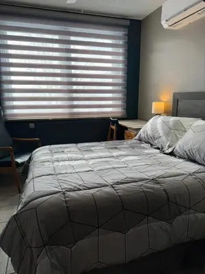 a bedroom with a large bed and a window at Manoir d'Youville in Châteauguay Heights