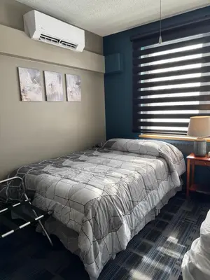 a bedroom with a bed and a window at Manoir d'Youville in Châteauguay Heights