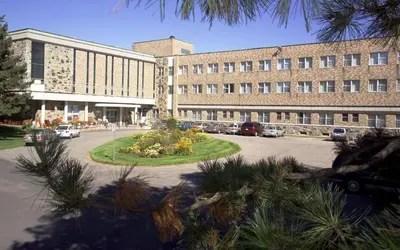 a large building with a parking lot in front of it at Manoir d'Youville in Châteauguay Heights