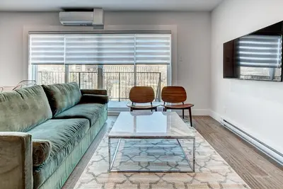 a living room with a couch and a table at Burgundy Lofts - Marché Atwater in Montréal