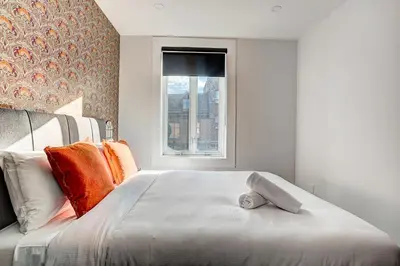 a bedroom with a large bed with a window at Burgundy Lofts - Marché Atwater in Montréal