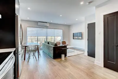 a living room with a couch and a table at Burgundy Lofts - Marché Atwater in Montréal