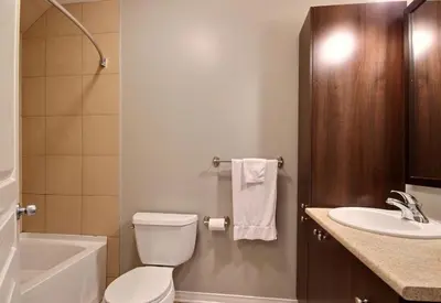 a bathroom with a white toilet and a sink at Bromont-Condo sur la montagne in Bromont