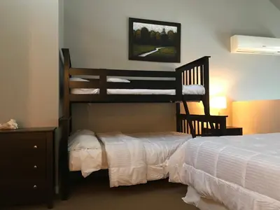 a bedroom with two bunk beds and a bed at Bromont-Condo sur la montagne in Bromont