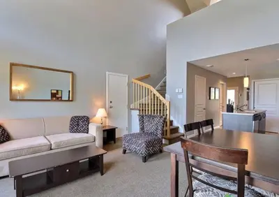 a living room with a couch and a table at Bromont-Condo sur la montagne in Bromont