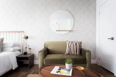 a living room with a chair and a table at Wonderful Studio in Little Italy with full bath by Den Stays in Montréal