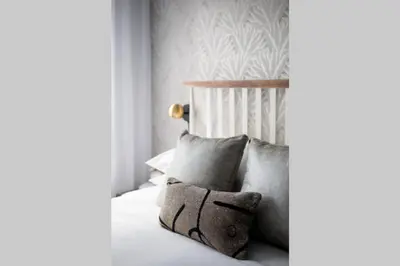 a bedroom with a bed with pillows on it at Wonderful Studio in Little Italy with full bath by Den Stays in Montréal