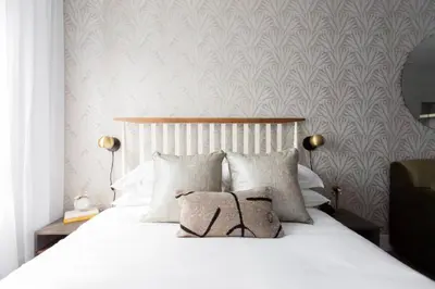 a bedroom with a white bed with two pillows at Wonderful Studio in Little Italy with full bath by Den Stays in Montréal