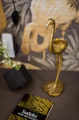 a gold statue of a bird sitting on a table at Fun & Funky Little Italy Studio with Full Kitchen by Den Stays in Montréal
