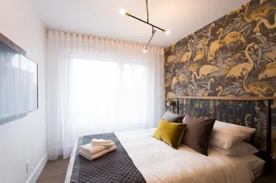 a bedroom with a bed with a wall mural at Fun & Funky Little Italy Studio with Full Kitchen by Den Stays in Montréal