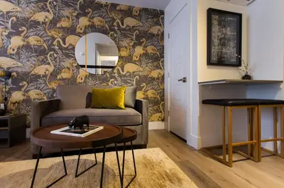 a living room with a couch and a table at Fun & Funky Little Italy Studio with Full Kitchen by Den Stays in Montréal