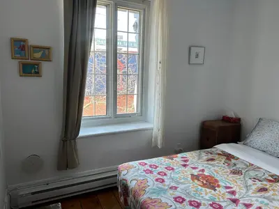 a bedroom with a bed and a window at À l'Adresse du Centre-Ville in Montréal