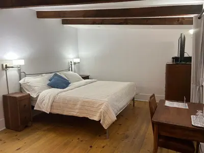 a bedroom with a bed and a table and a tv at À l'Adresse du Centre-Ville in Montréal