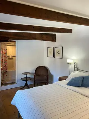 a bedroom with a large bed and a chair at À l'Adresse du Centre-Ville in Montréal