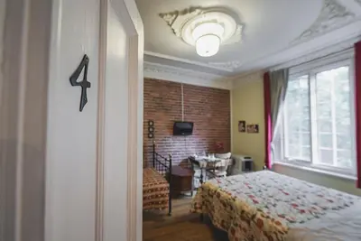a bedroom with a bed and a brick wall at À l'Adresse du Centre-Ville in Montréal