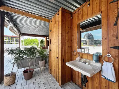 a bathroom with a sink in a wooden wall at Auberge du Plateau in Montréal