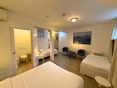a room with a bedroom with a bed and a desk at Auberge du Plateau in Montréal