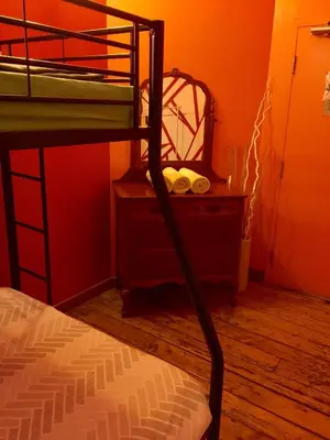 a bedroom with a bunk bed and a mirror at Auberge Alternative in Montréal