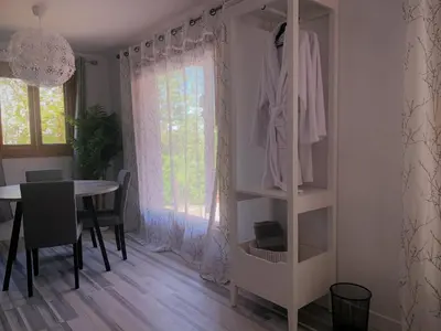 a room with a table and a white book shelf at La Bohème - Bed & Breakfast in Bromont