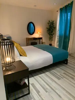a bedroom with a large bed and a table at La Bohème - Bed & Breakfast in Bromont