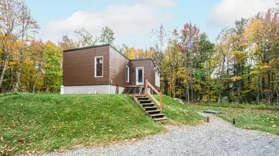 a small house on a hill with a staircase at Sutton Wellness Cabin #265 unité du haut in Sutton