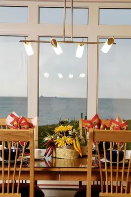 a dining room table with a view of the ocean at Chalets Multivoile 4 Saisons in Trois-Rivières
