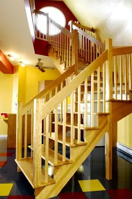 a wooden staircase in a room with yellow walls at Chalets Multivoile 4 Saisons in Trois-Rivières
