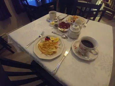 a table with a plate of food and a cup of coffee at Dans Les Bras de Memphré in Magog-Orford